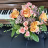 Bouquet of peach and pink roses in a glass vase