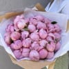 Bouquet of pink peonies wrapped in white and kraft paper