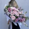 Woman holding a large bouquet of pink and white flowers