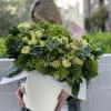 Large green bouquet with roses and succulents in a white box