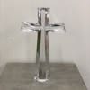 Clear glass cross standing on a surface
