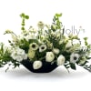 An eye-catching centerpiece of panda anemone, scabious, astilbe, freesia, ranunculus, stock, roses