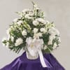 This is an all white tribute basket for the funeral service. 