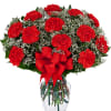 One dozen long lasting red carnations arranged in a clear glass vase