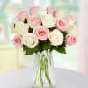 Bouquet of pink and white roses in a clear glass vase