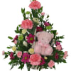 Pink and magenta flower arrangement with a pink teddy bear