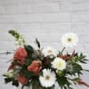 Cozy neutral florals in a clear glass vase with fall foliage, dark
