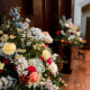 Large mixed floral arrangement with blue, white, pink, and yellow blooms