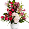 A luxurious arrangement of elegant pink and red roses, fragrant lilies, lush