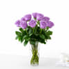 Lavender roses arranged in a clear glass vase
