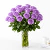 Lavender roses arranged in a clear glass vase