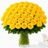Large bouquet of yellow roses in a clear glass vase
