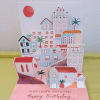 Pop-up birthday card with colorful houses and palm trees