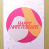 Happy anniversary greeting card with pink and peach abstract circle design and small star accents
