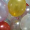Cluster of pastel and metallic balloons in yellow, white, pink, and red tones
