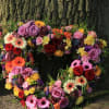 Heart-shaped floral wreath with roses and gerbera daisies