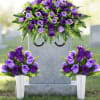 Purple rose funeral arrangement on a gravestone with two matching vase bouquets