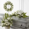 White floral funeral casket spray, wreath, and basket arrangement