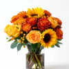 Bouquet of yellow and orange flowers in a clear glass vase
