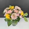 Pink and yellow mixed bouquet in a clear glass vase