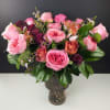 Bouquet of pink and burgundy roses in a glass vase