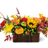 Autumn floral arrangement with sunflowers, roses, and fruit in a rectangular basket