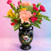 Colorful bouquet in a black painted vase