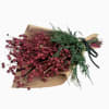 Bundle of red dried flowers wrapped in brown paper with a black ribbon
