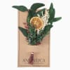 Dried bouquet with an orange slice and greenery on a kraft card