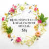 Assorted small pink, yellow, and white flowers arranged in a loose circular frame around text on white background