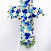 Blue and white floral cross on a white stand