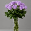Lavender roses arranged in a clear glass vase