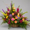 Large mixed flower arrangement in a wicker basket