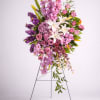 Tall floral spray with pink, purple, and white blooms on a metal stand