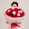 A romantic bouquet of rich fuchsia roses paired with delicate blush spray