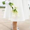 Bride holding a bouquet of white calla lilies