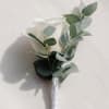 White rose boutonniere with eucalyptus leaves and a wrapped stem