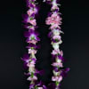Purple and pink flower lei on a black background