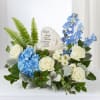 Blue and white floral sympathy arrangement with a memorial stone