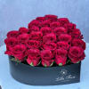 Heart-shaped box filled with red roses
