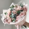 Bouquet of pale pink roses wrapped in blush paper