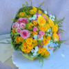 Bouquet of yellow and pink roses with small white flowers