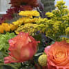 Mixed bouquet with orange roses, yellow chrysanthemums, and red blooms