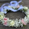 Floral crown of pink and white roses with a lavender ribbon
