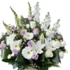 Basket arrangement of white lilies, roses, and daisies with pale lavender roses