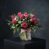 Twelve pink premium roses with fillers and and ribbon.