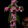 A graceful floral cross designed to honor a life of faith, love