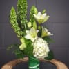 Fresh design including Bells of Ireland, hydrangea, lily, rose... and accents. 
STANDARD: