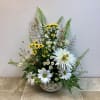 A bee-themed bowl and bee ornament give this vibrant and cheerful floral