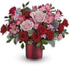 Bouquet of red and pink roses in a red vase